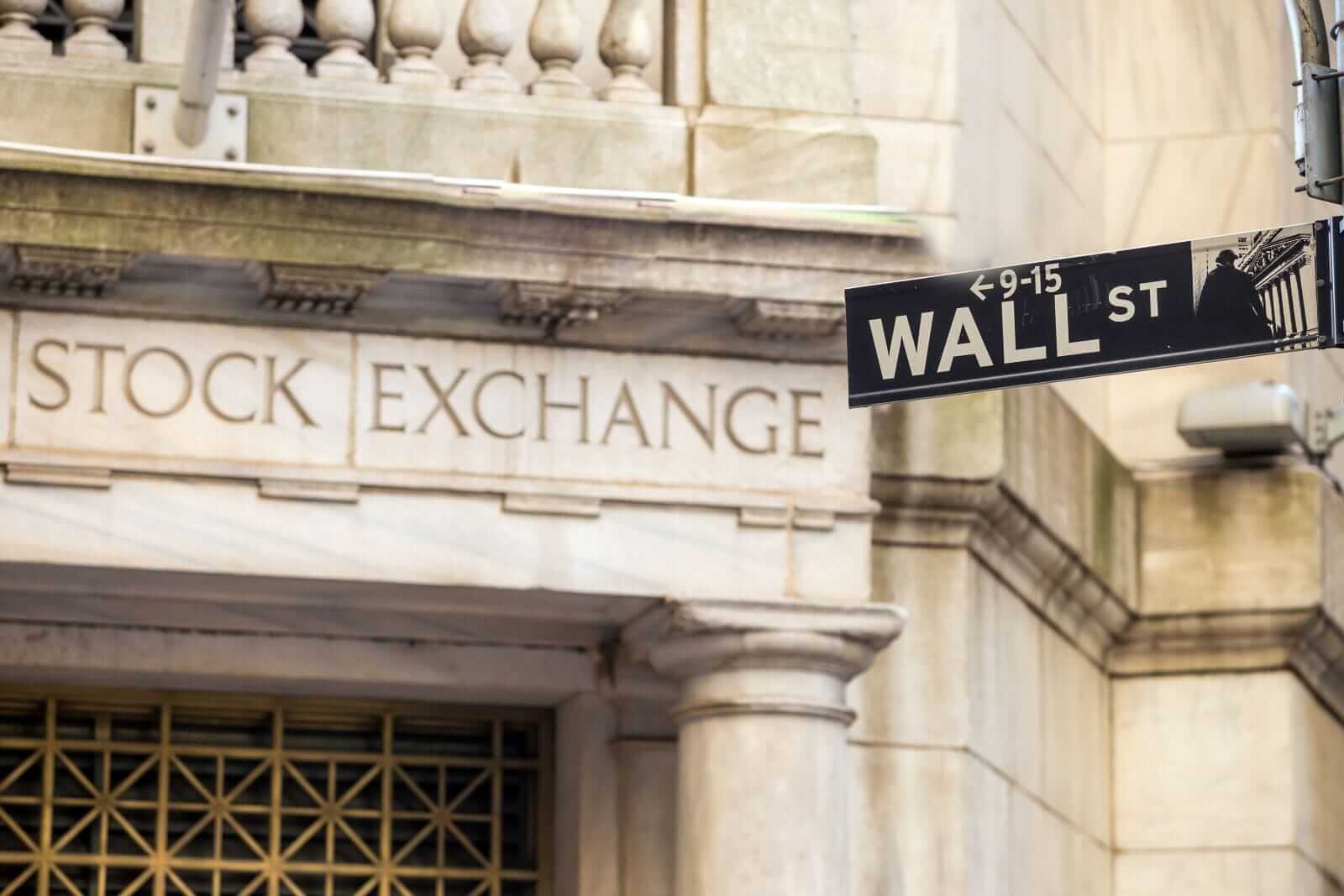 Wall street sign in New York City by f11photo via Shutterstock